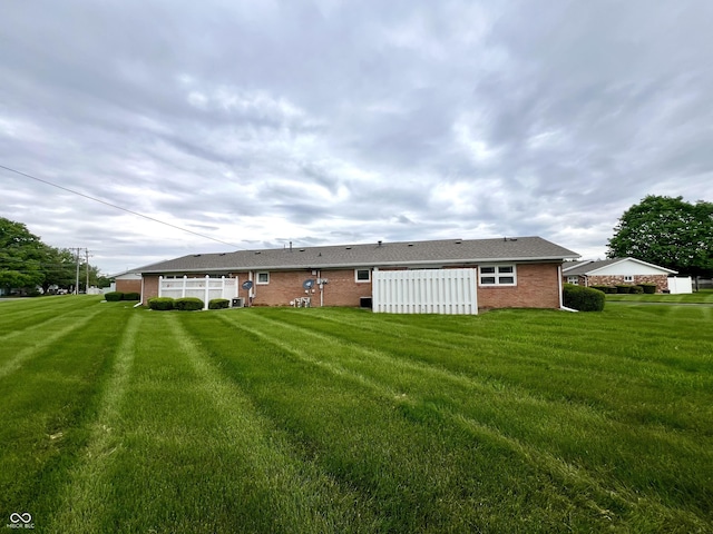 2508 Pamela Ct, Anderson, IN 46012 - back of house featuring brick siding and a yard
