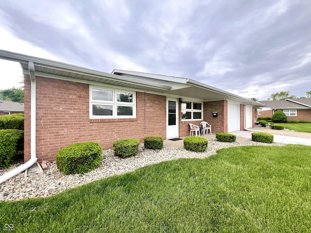 2508 Pamela Ct, Anderson, IN 46012 - single story home with a front yard, a garage, brick siding, and concrete driveway