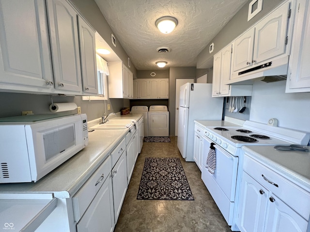 2508 Pamela Ct, Anderson, IN 46012 - kitchen featuring separate washer and dryer, white appliances, under cabinet range hood, white cabinetry, and light countertops