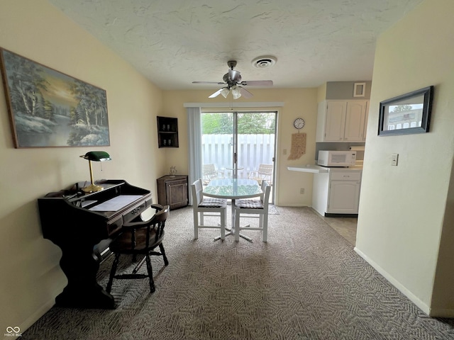 2508 Pamela Ct, Anderson, IN 46012 - dining area featuring light carpet, ceiling fan, baseboards, a desk, and a textured ceiling
