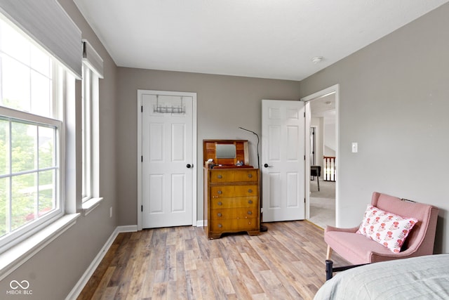 bedroom featuring light wood-style flooring and baseboards