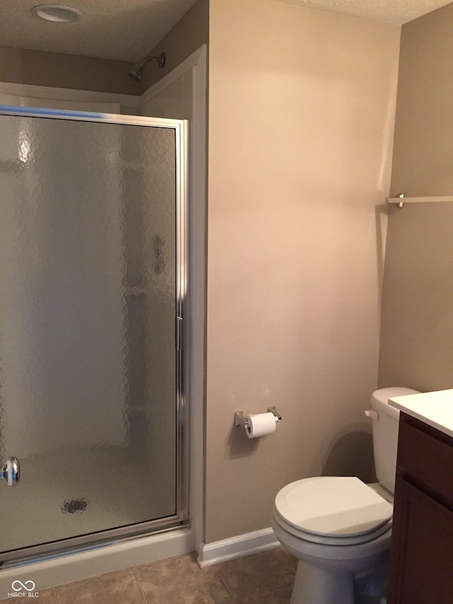 6304 El Paso St, Whitestown, IN 46075 - bathroom with a stall shower, vanity, tile patterned flooring, toilet, and a textured ceiling