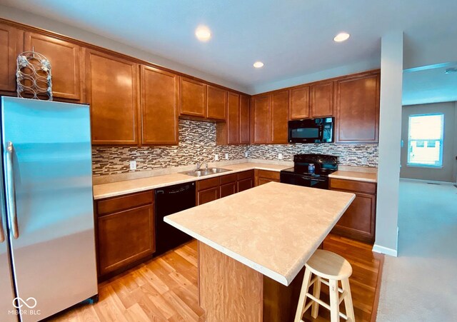 6304 El Paso St, Whitestown, IN 46075 - kitchen featuring black appliances, a sink, light wood-type flooring, light countertops, and recessed lighting