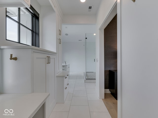 hallway featuring light tile patterned floors