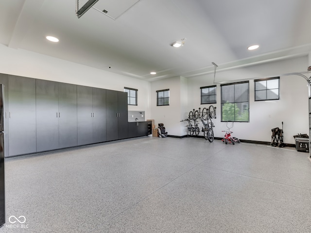 garage featuring recessed lighting and baseboards