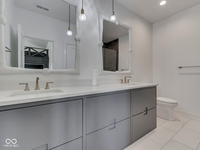 bathroom featuring double vanity, toilet, recessed lighting, baseboards, and a shower