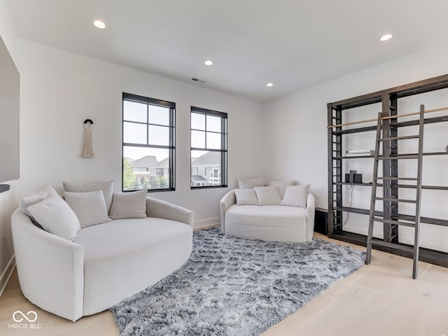 living area featuring recessed lighting, light wood finished floors, and baseboards