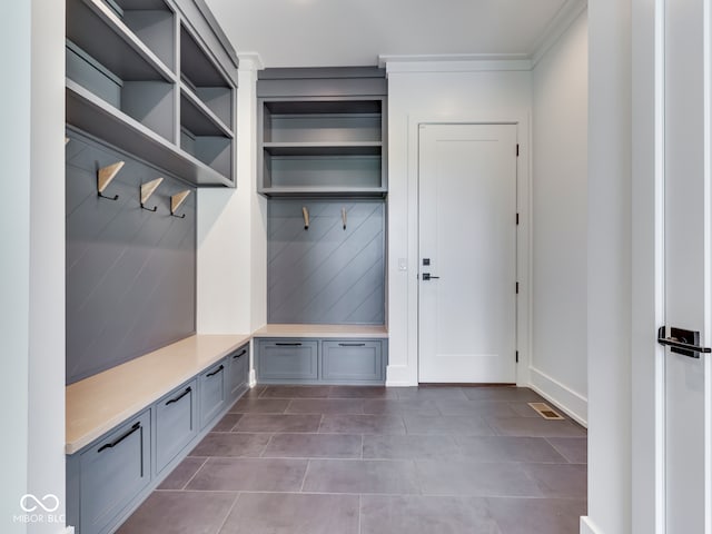 mudroom featuring tile patterned flooring and crown molding