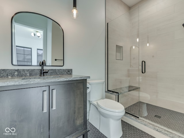full bathroom with a stall shower, toilet, tile patterned floors, and vanity