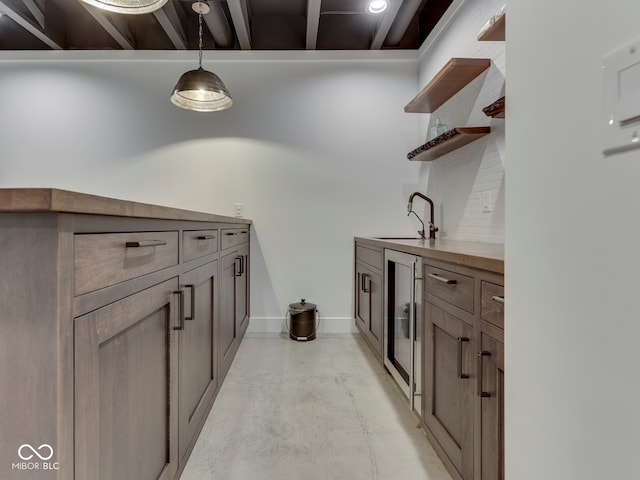 laundry area featuring beverage cooler and bar with sink