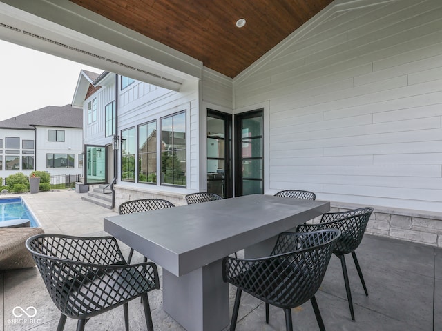 view of patio / terrace with an outdoor pool and entry steps