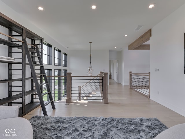 interior space with recessed lighting, a chandelier, wood finished floors, and baseboards