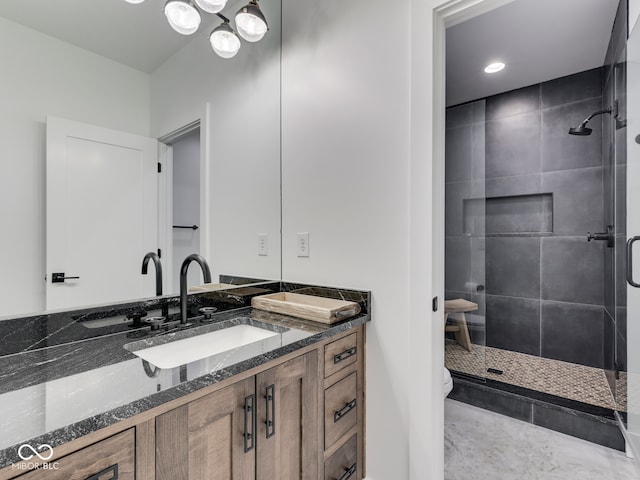 full bath with a stall shower, vanity, and toilet