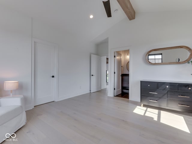 bedroom featuring light wood finished floors, ensuite bathroom, and baseboards