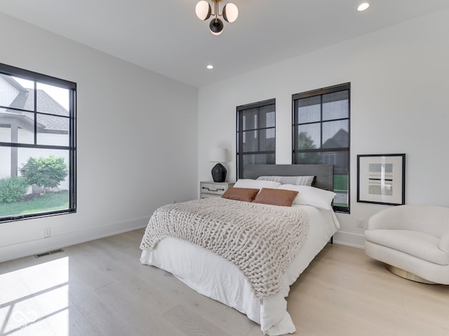 bedroom with light wood-type flooring, recessed lighting, and baseboards