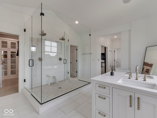 full bath featuring a shower stall, vanity, and lofted ceiling