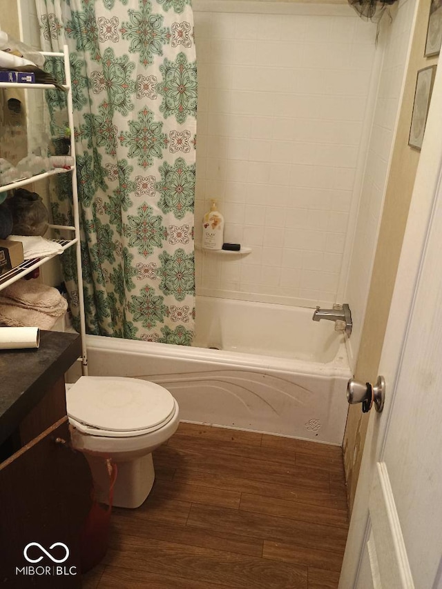 bathroom featuring wood finished floors, shower / bath combination with curtain, toilet, and vanity