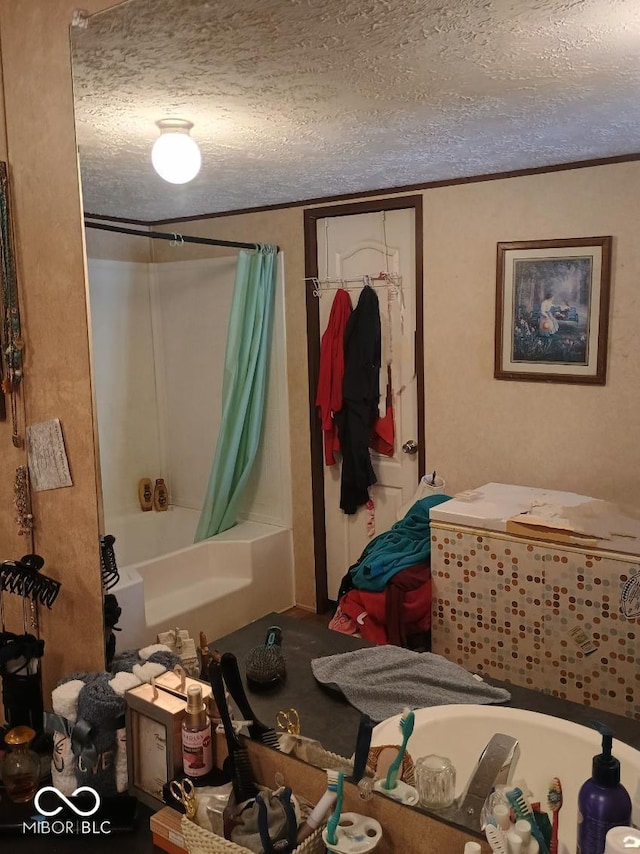 bathroom featuring a textured ceiling, shower / tub combo, and crown molding