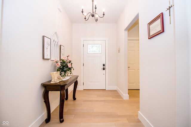 2686 Lafayette Ave, Columbus, IN 47201 - foyer with a chandelier, light wood-type flooring, and baseboards