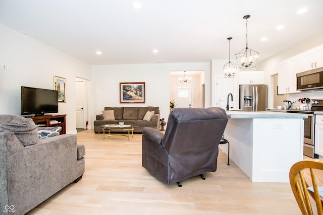 2686 Lafayette Ave, Columbus, IN 47201 - living room featuring a chandelier, light wood-style floors, and recessed lighting