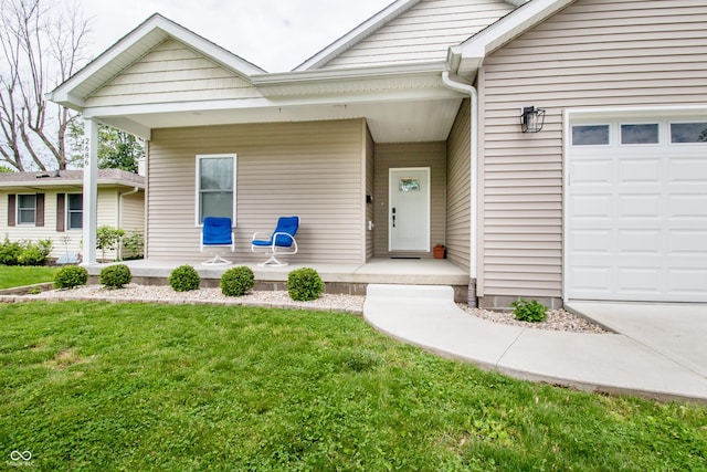 2686 Lafayette Ave, Columbus, IN 47201 - doorway to property featuring covered porch, a lawn, and a garage