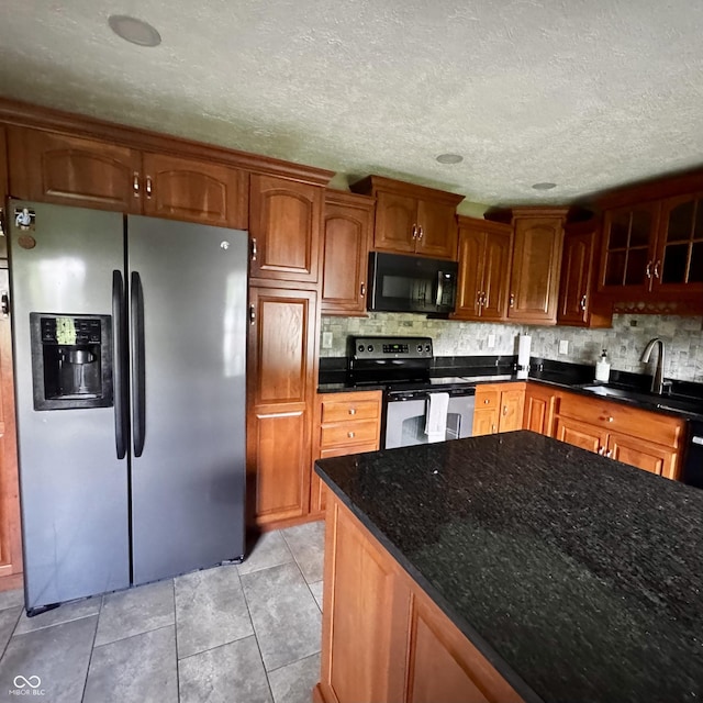 3559 S County Road 475 E, Plainfield, IN 46168 - kitchen with appliances with stainless steel finishes, a sink, decorative backsplash, dark stone counters, and light tile patterned flooring