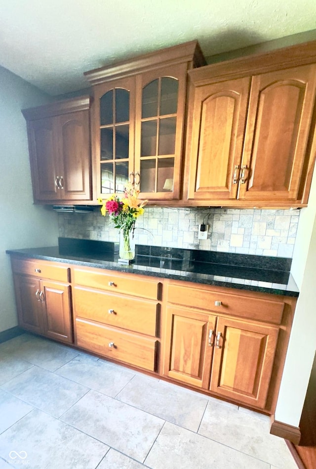 3559 S County Road 475 E, Plainfield, IN 46168 - kitchen with decorative backsplash, glass insert cabinets, baseboards, and light tile patterned floors