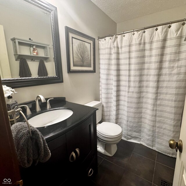 3559 S County Road 475 E, Plainfield, IN 46168 - full bathroom with a textured ceiling, toilet, tile patterned flooring, vanity, and a shower with curtain