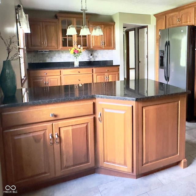 3559 S County Road 475 E, Plainfield, IN 46168 - kitchen featuring stainless steel fridge with ice dispenser, glass insert cabinets, backsplash, hanging light fixtures, and dark stone counters
