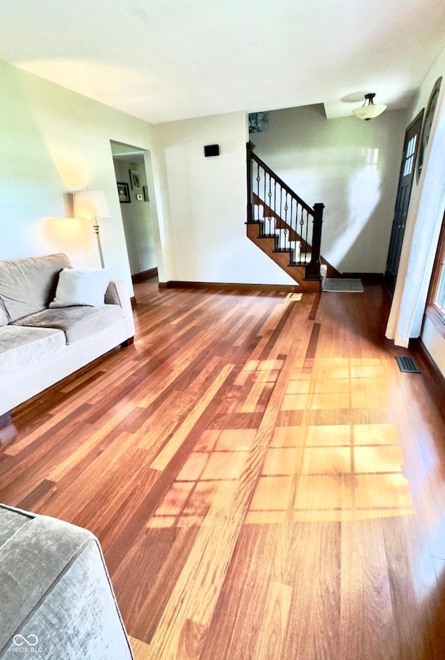 3559 S County Road 475 E, Plainfield, IN 46168 - unfurnished living room with wood finished floors, stairway, and baseboards