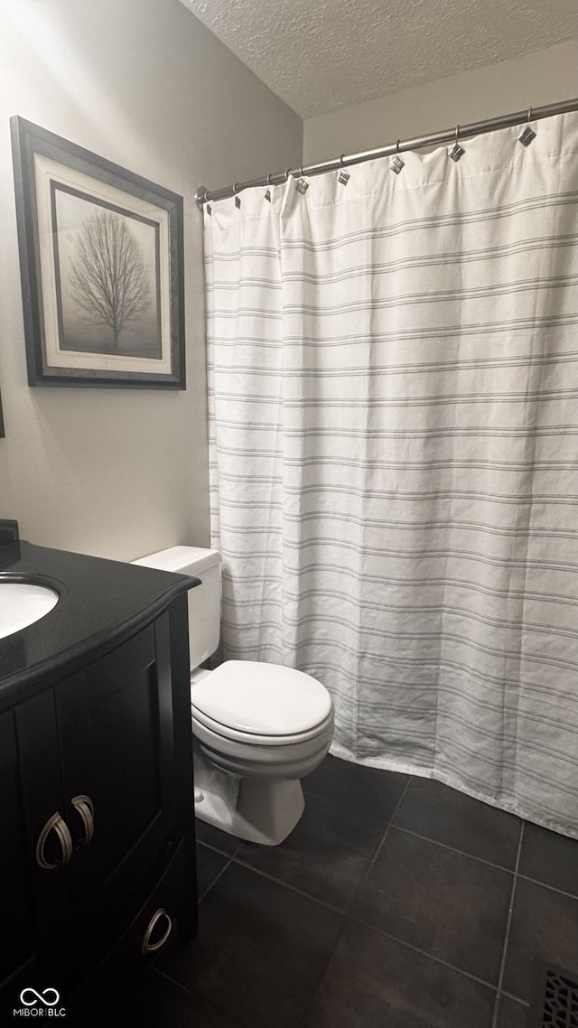 3559 S County Road 475 E, Plainfield, IN 46168 - full bathroom featuring a textured ceiling, tile patterned floors, vanity, toilet, and a shower with shower curtain