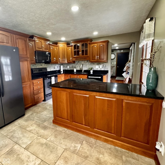 3559 S County Road 475 E, Plainfield, IN 46168 - kitchen with black appliances, decorative backsplash, brown cabinetry, glass insert cabinets, and a sink