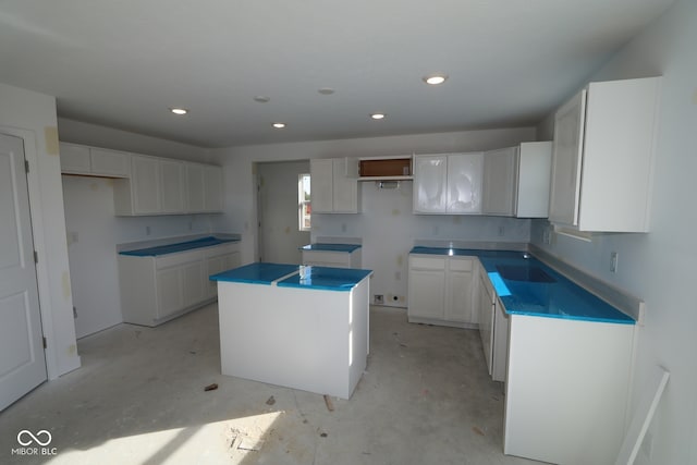 7323 Waylon Way, Indianapolis, IN 46239 - kitchen featuring a kitchen island, concrete flooring, recessed lighting, and white cabinets