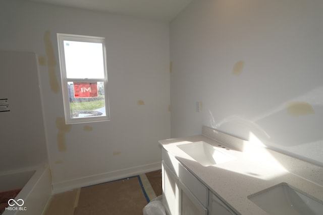 7323 Waylon Way, Indianapolis, IN 46239 - bathroom with double vanity, baseboards, and a bath