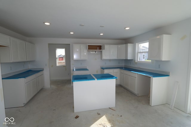 7323 Waylon Way, Indianapolis, IN 46239 - kitchen with a center island, concrete floors, recessed lighting, and white cabinetry