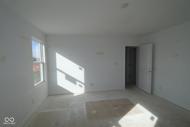 7323 Waylon Way, Indianapolis, IN 46239 - empty room featuring baseboards and unfinished concrete floors