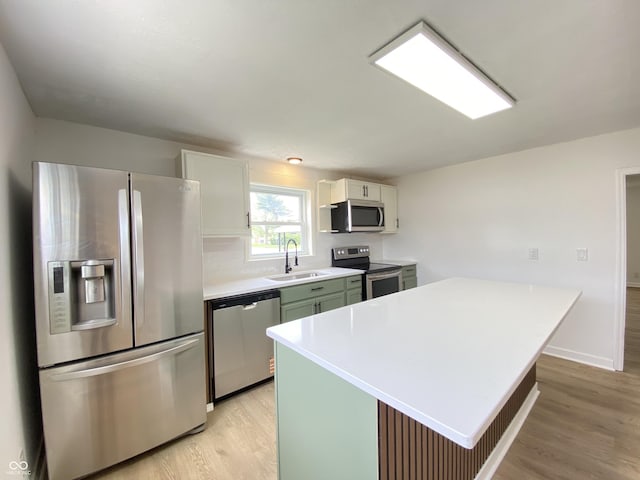 453 Illinois St, Fortville, IN 46040 - kitchen with stainless steel appliances, a sink, light wood-style flooring, and light countertops