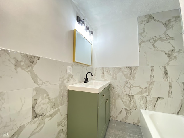 453 Illinois St, Fortville, IN 46040 - bathroom with tile walls, a bathtub, vanity, and wainscoting