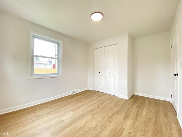 453 Illinois St, Fortville, IN 46040 - unfurnished bedroom featuring light wood finished floors, baseboards, and a closet