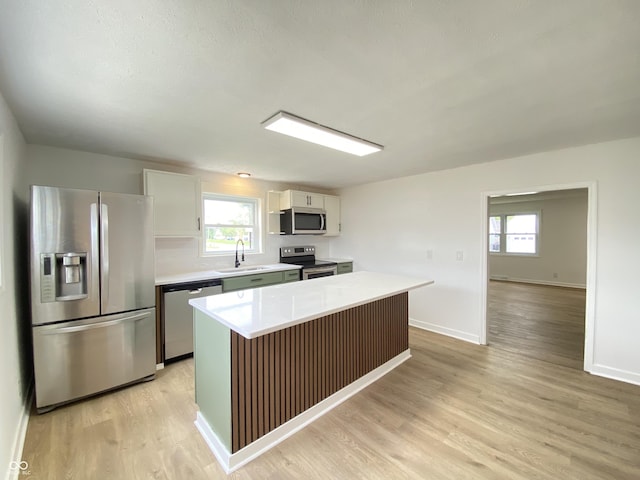 453 Illinois St, Fortville, IN 46040 - kitchen featuring appliances with stainless steel finishes, a sink, light countertops, and healthy amount of natural light