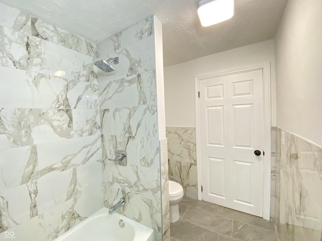453 Illinois St, Fortville, IN 46040 - bathroom with tile walls, toilet, bathtub / shower combination, and a wainscoted wall