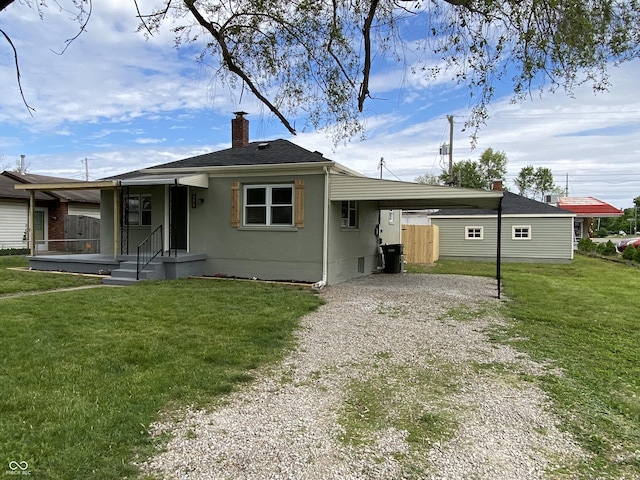453 Illinois St, Fortville, IN 46040 - view of front facade with gravel driveway, a chimney, and an attached carport