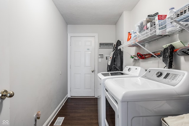 11419 Niagara Dr, Fishers, IN 46037 - laundry area with washing machine and dryer, dark wood finished floors, baseboards, and a textured ceiling