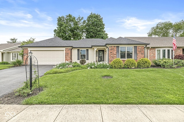 12388 Camberley Ln, Carmel, IN 46033 - single story home with brick siding, asphalt driveway, a garage, and a front lawn