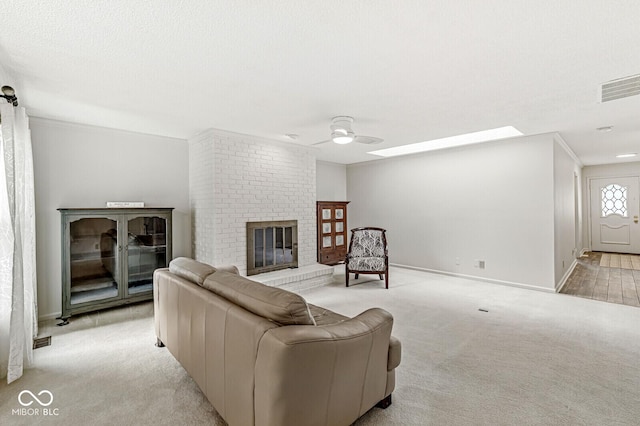 12388 Camberley Ln, Carmel, IN 46033 - living area featuring ceiling fan, light colored carpet, a brick fireplace, and baseboards