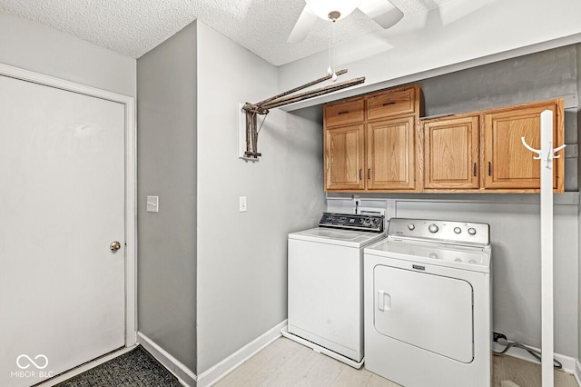 12388 Camberley Ln, Carmel, IN 46033 - laundry area featuring cabinet space, a ceiling fan, independent washer and dryer, a textured ceiling, and baseboards