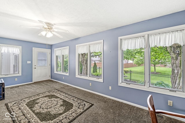 12388 Camberley Ln, Carmel, IN 46033 - carpeted entryway featuring a ceiling fan, baseboards, and a textured ceiling