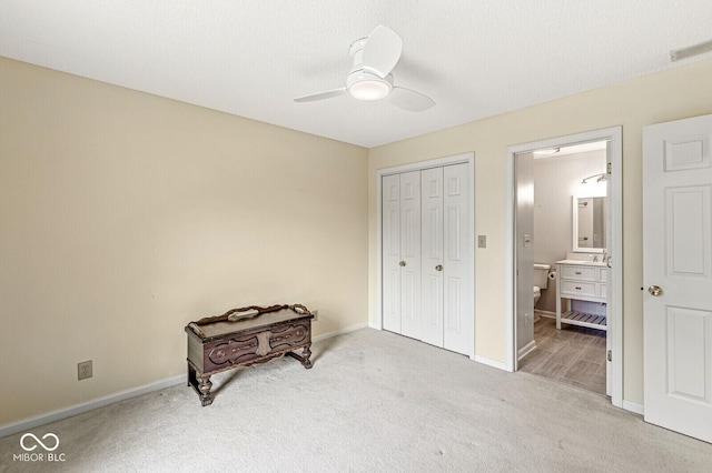 12388 Camberley Ln, Carmel, IN 46033 - bedroom with carpet, baseboards, a closet, ensuite bath, and ceiling fan