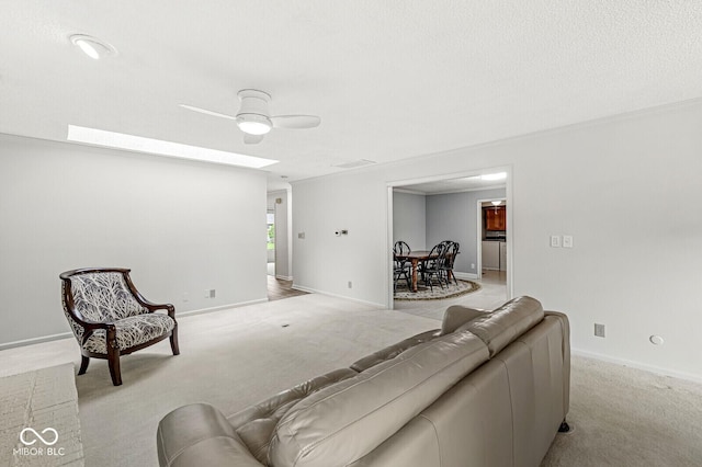 12388 Camberley Ln, Carmel, IN 46033 - living area featuring light colored carpet, a ceiling fan, and baseboards