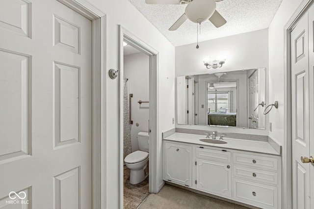12388 Camberley Ln, Carmel, IN 46033 - ensuite bathroom featuring ceiling fan, vanity, toilet, and a textured ceiling